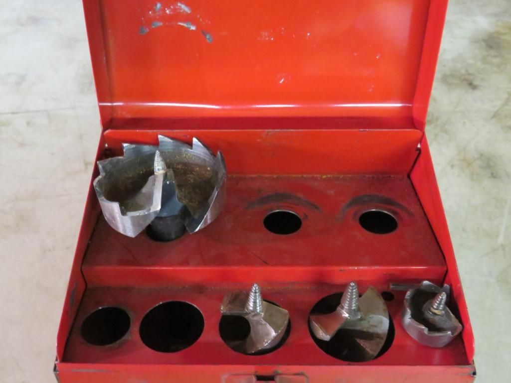 Red toolbox containing hole saws.