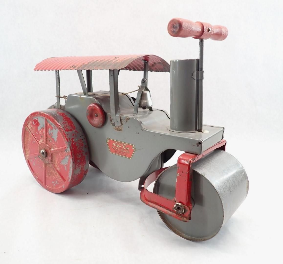 Vintage metal toy steamroller, gray and red, with a sunshade and handle.