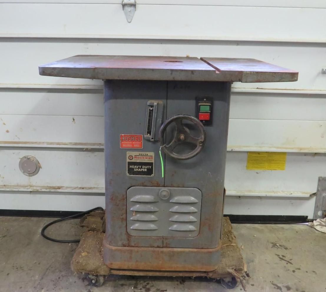 Gray table saw on a wheeled base, with a tabletop and control panel.
