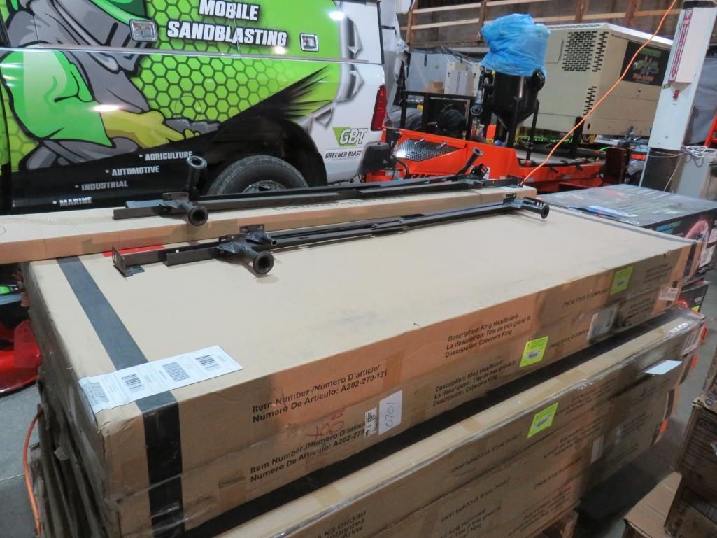 Stacked cardboard boxes with long, metal rods on top.
