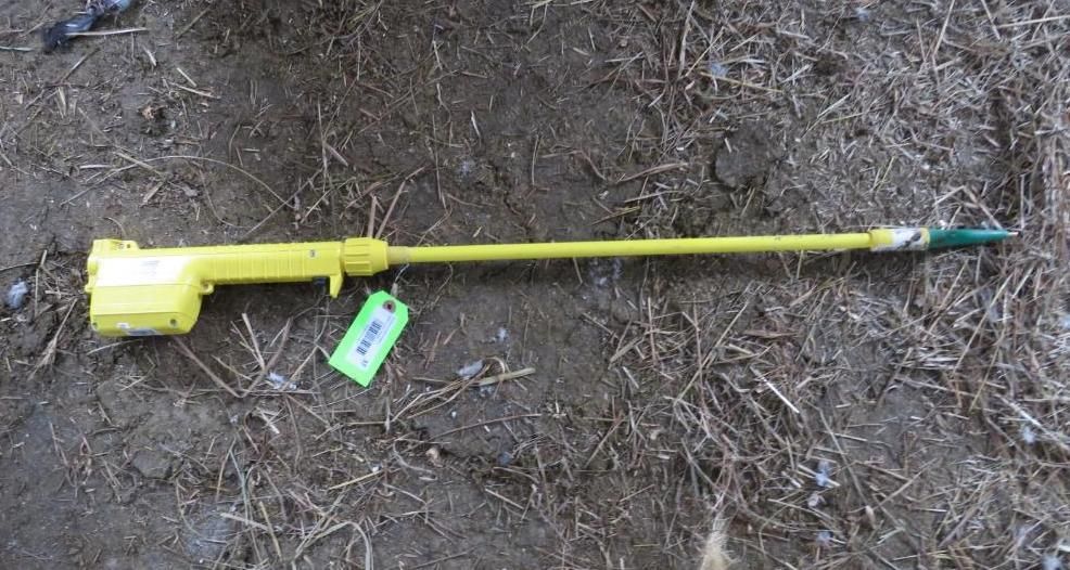 Yellow spray wand with a green tag attached.