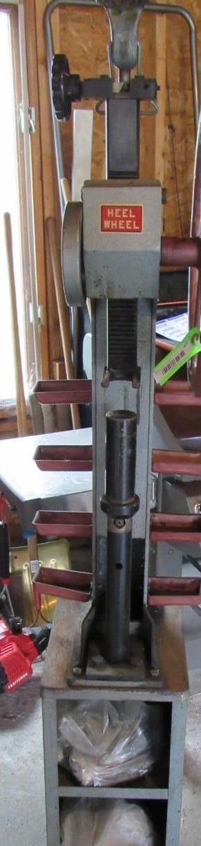 An industrial metal press machine is in a workshop setting.