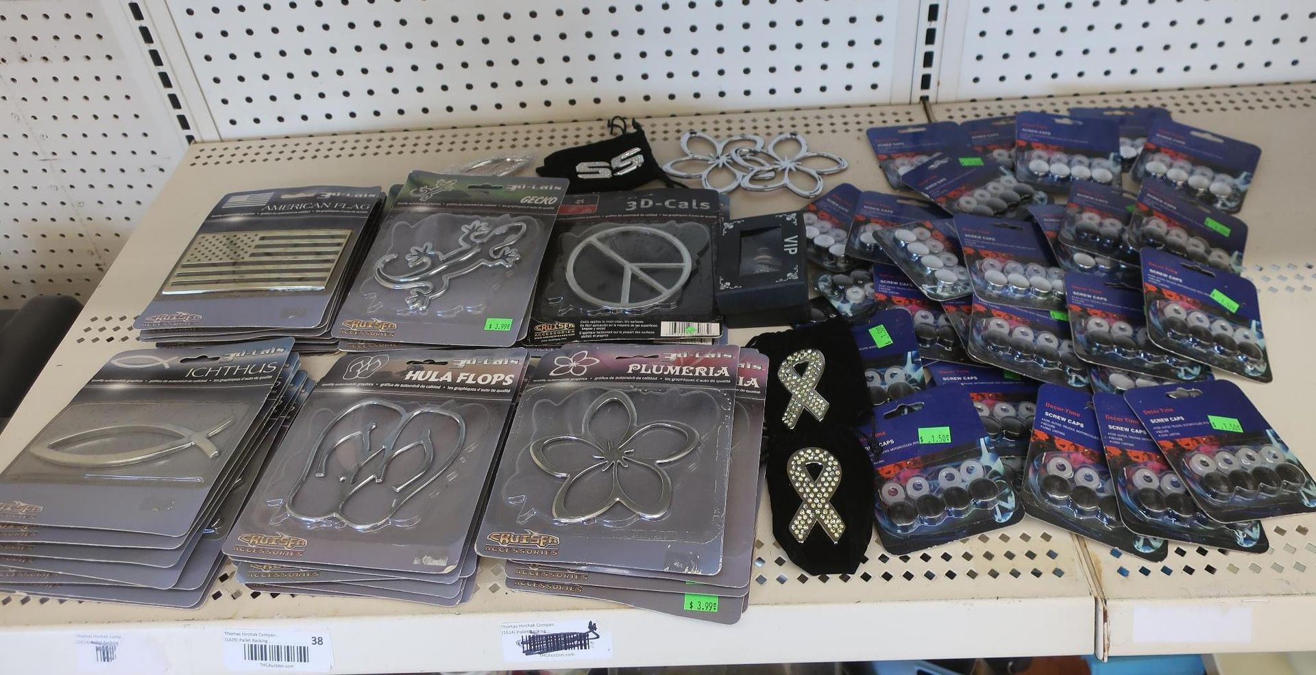 Shelf display with various metal-themed car accessories, pins and patches.