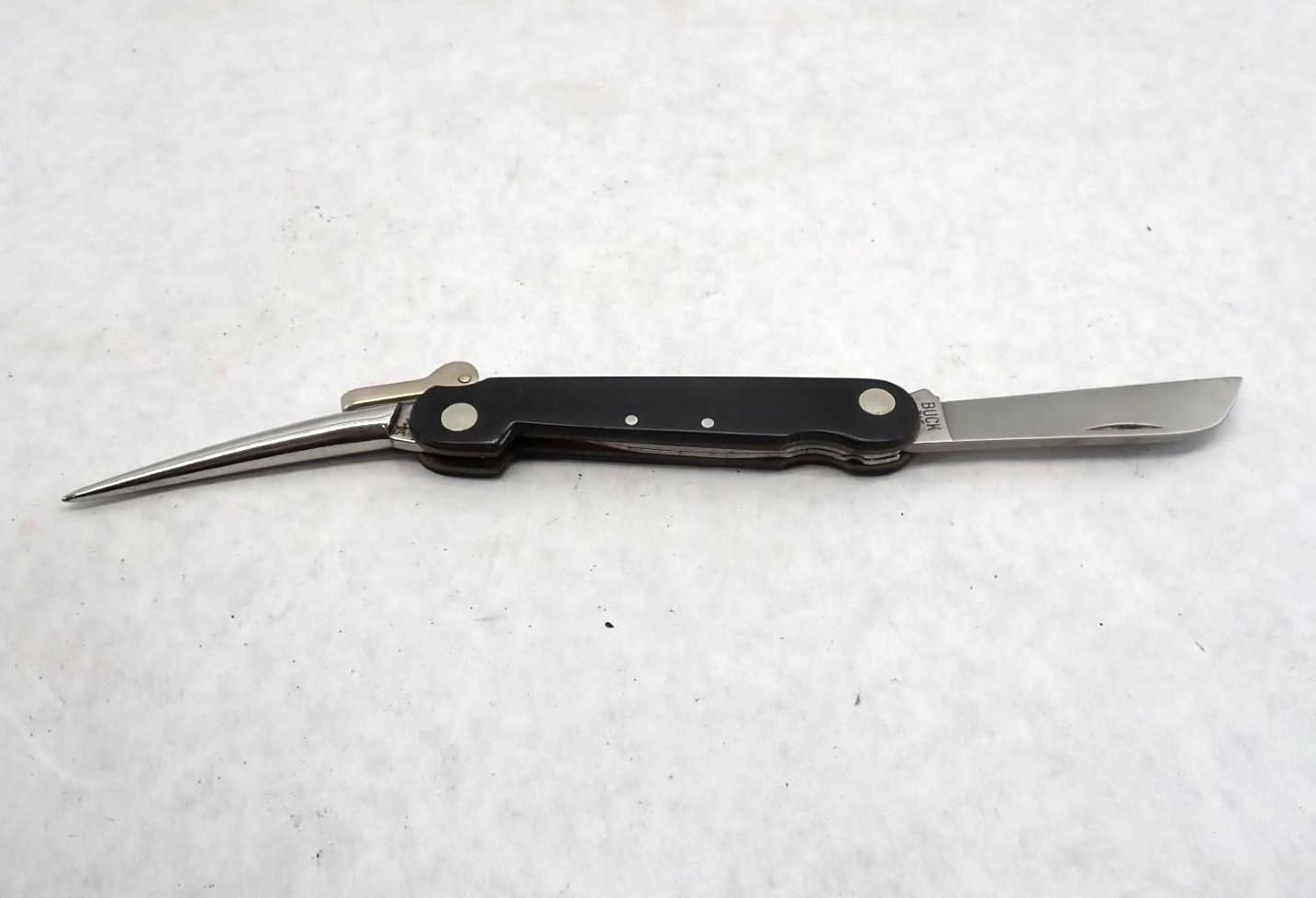 Pocket knife with a black handle, a blade, and a sharp, pointed tool.