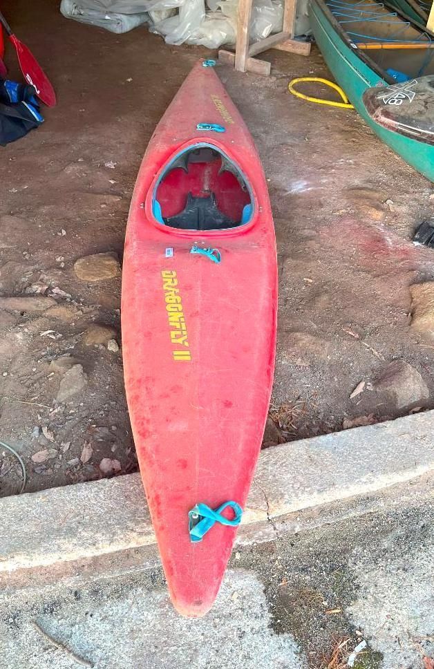 Red kayak with blue straps.