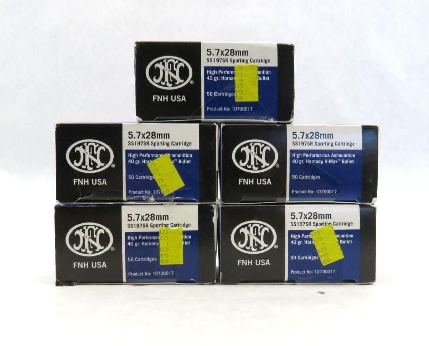 Six boxes of FN 5.7x28mm ammunition, labeled with FN USA logo, stacked on white surface. Each box has a yellow price sticker.
