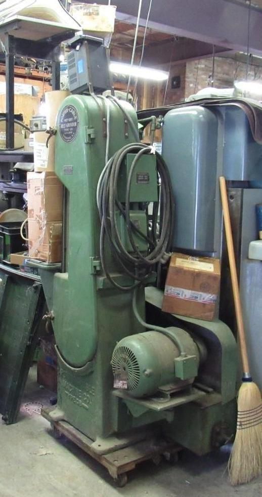Green industrial metalworking machine with motor and coiled cable.