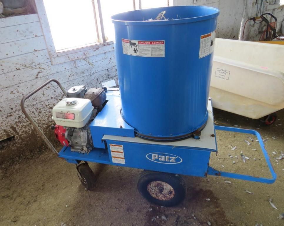 Blue Patz bale chopper machine on wheels.