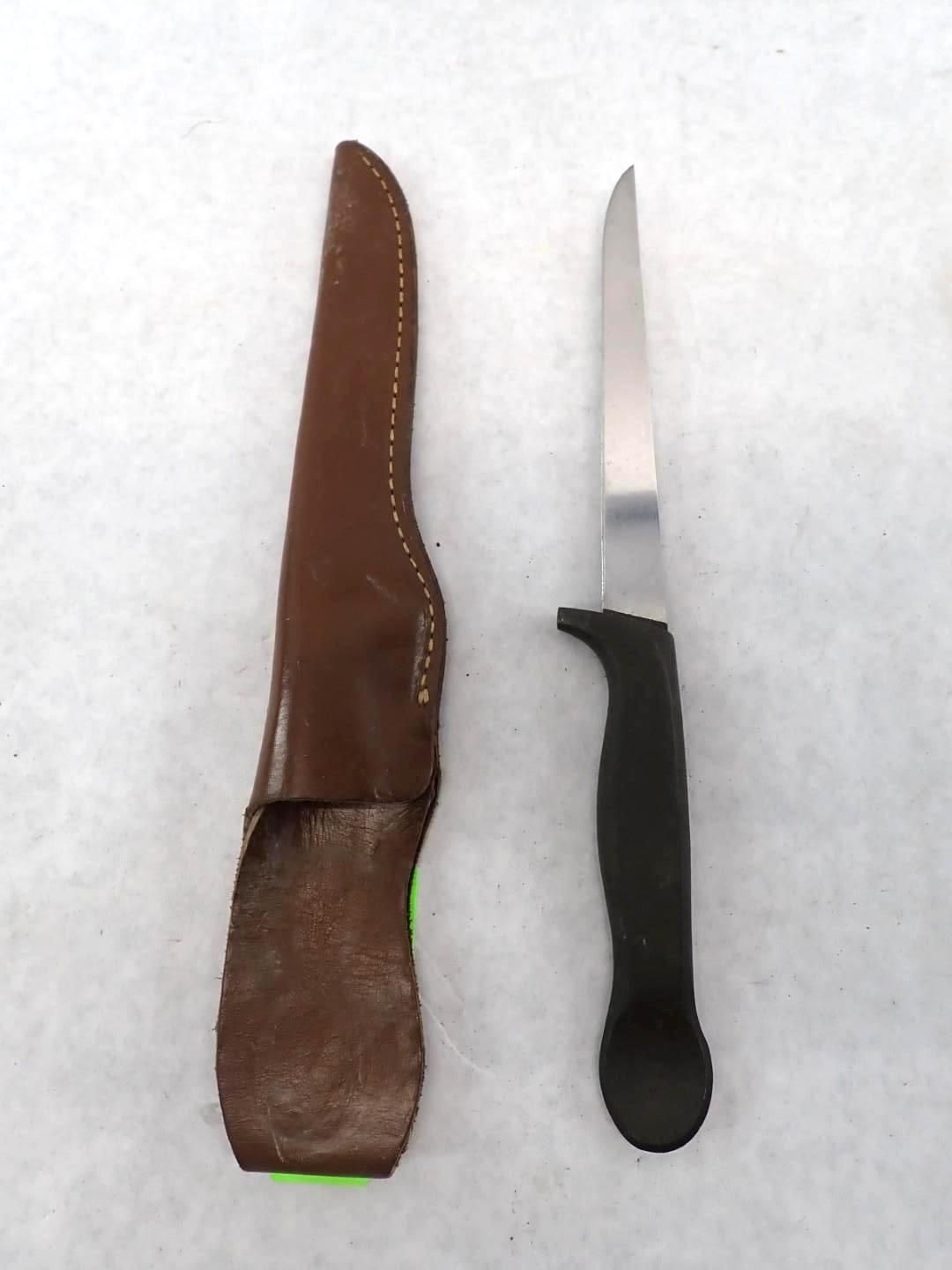 Knife with a black handle and a brown leather sheath.
