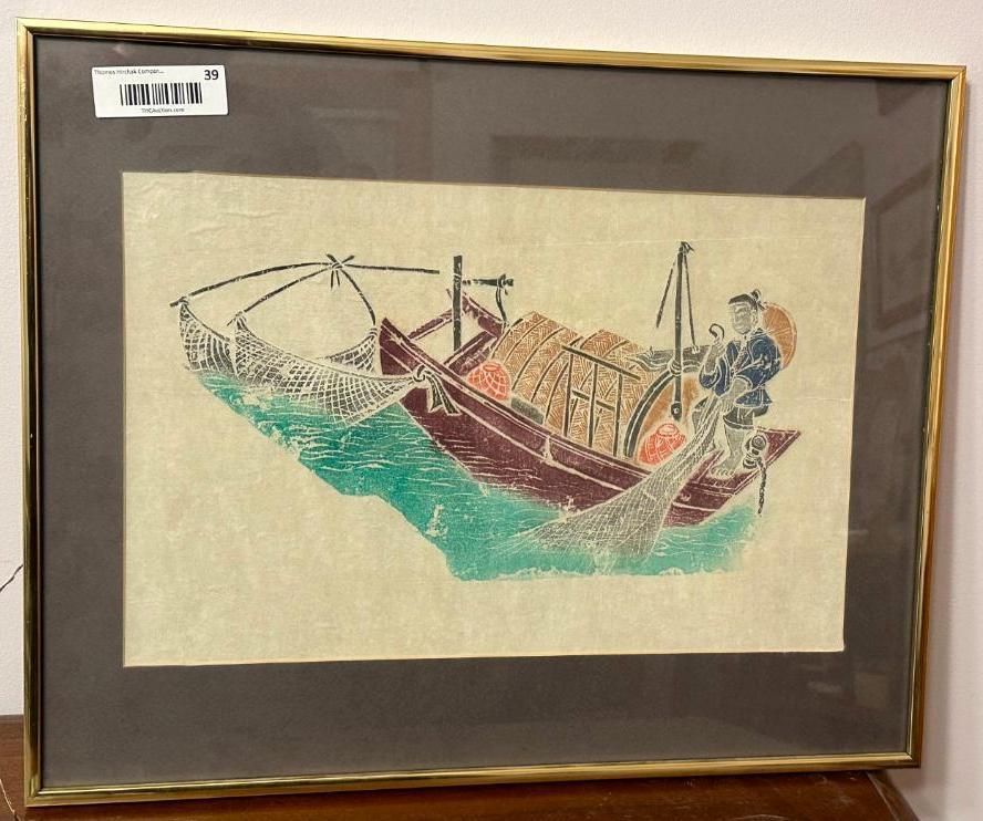 Framed artwork of a fishing boat with nets, waves, and a figure, in a gold frame.