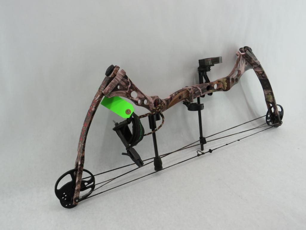 Camouflage compound bow on a light gray background.
