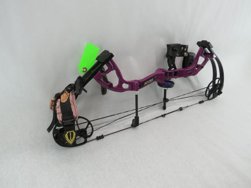 Purple and black compound bow with accessories, against a white background.