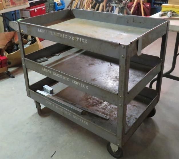 Three-tiered metal utility cart on wheels with 