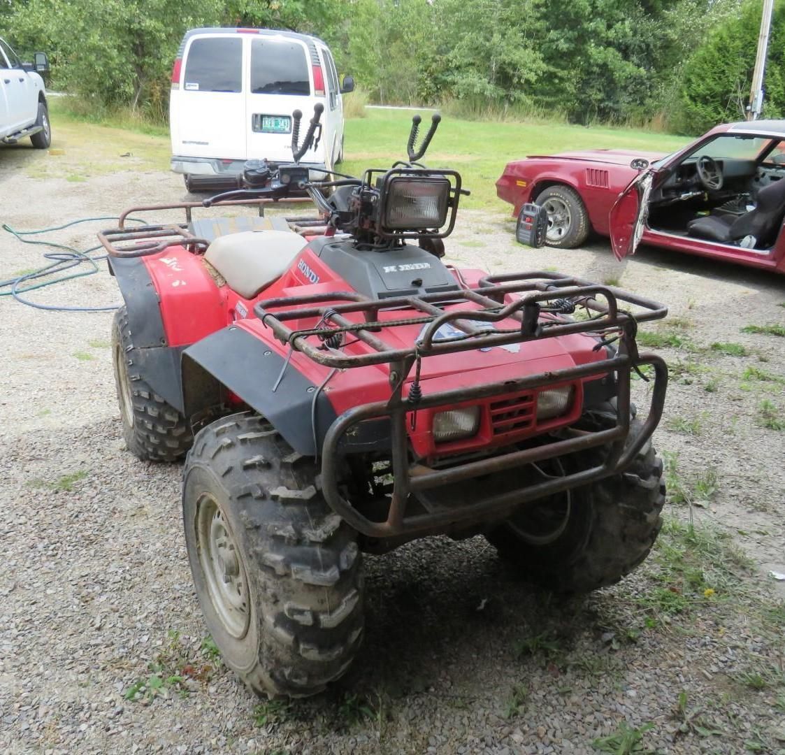 Red ATV parked outdoors.