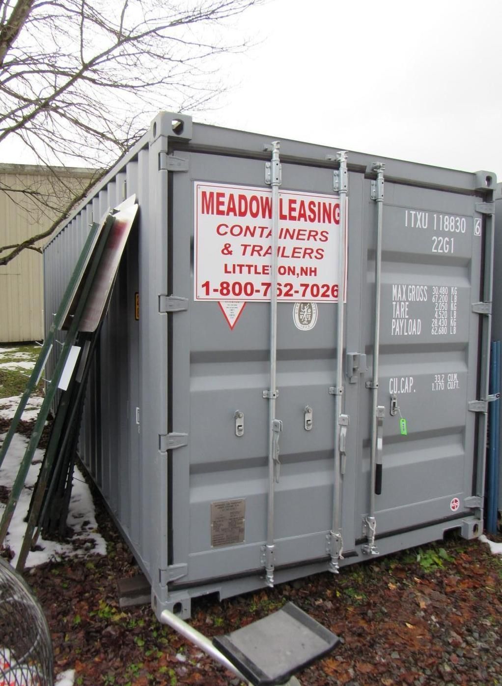 Gray shipping container outdoors.