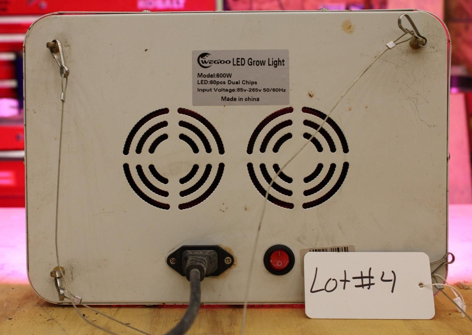 Back view of a white LED grow light with two fans, a power cord, and a lot number tag.