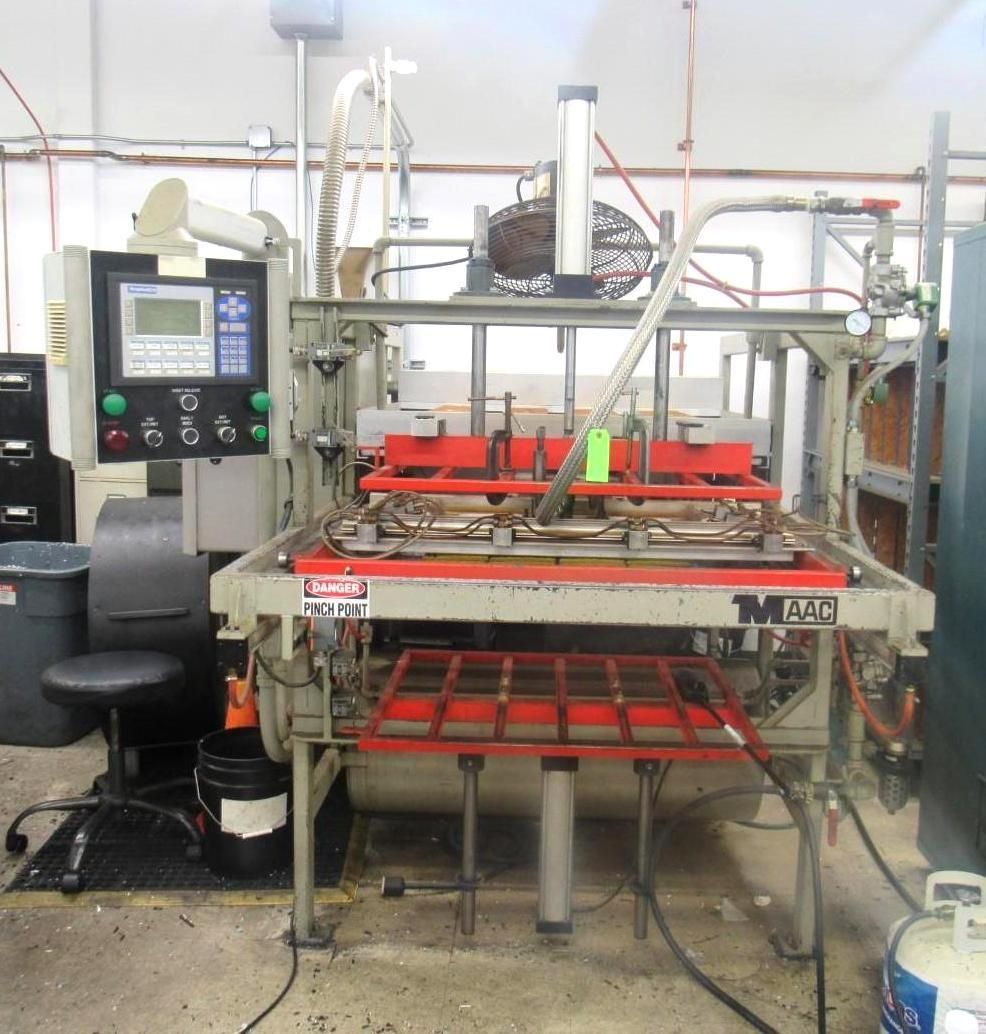 Industrial machine with red and gray components, control panel, and safety features.
