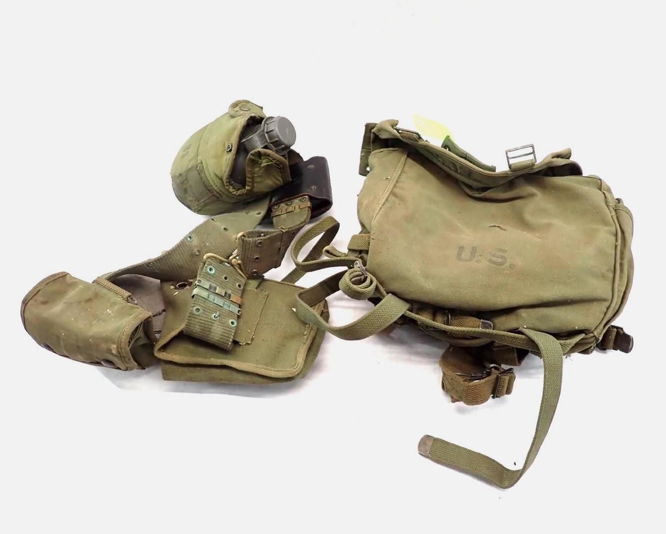 Olive green military field gear: canteen, shoulder bag, and belt with pouches.