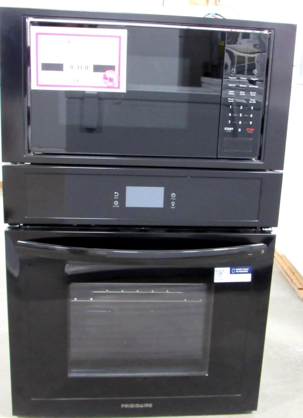Black kitchen appliance stack: microwave, oven, and warming drawer.