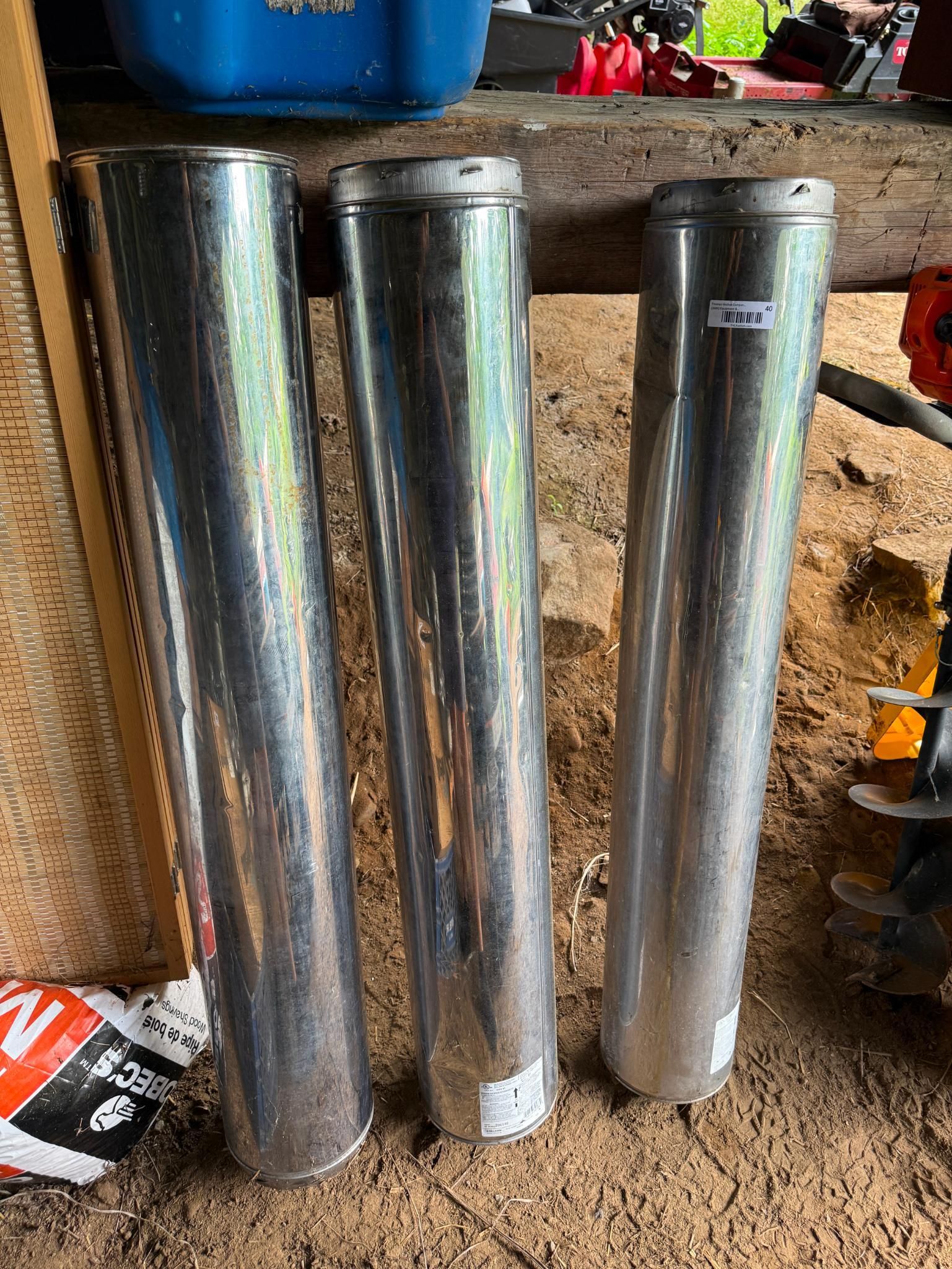 Three shiny, cylindrical metal objects.