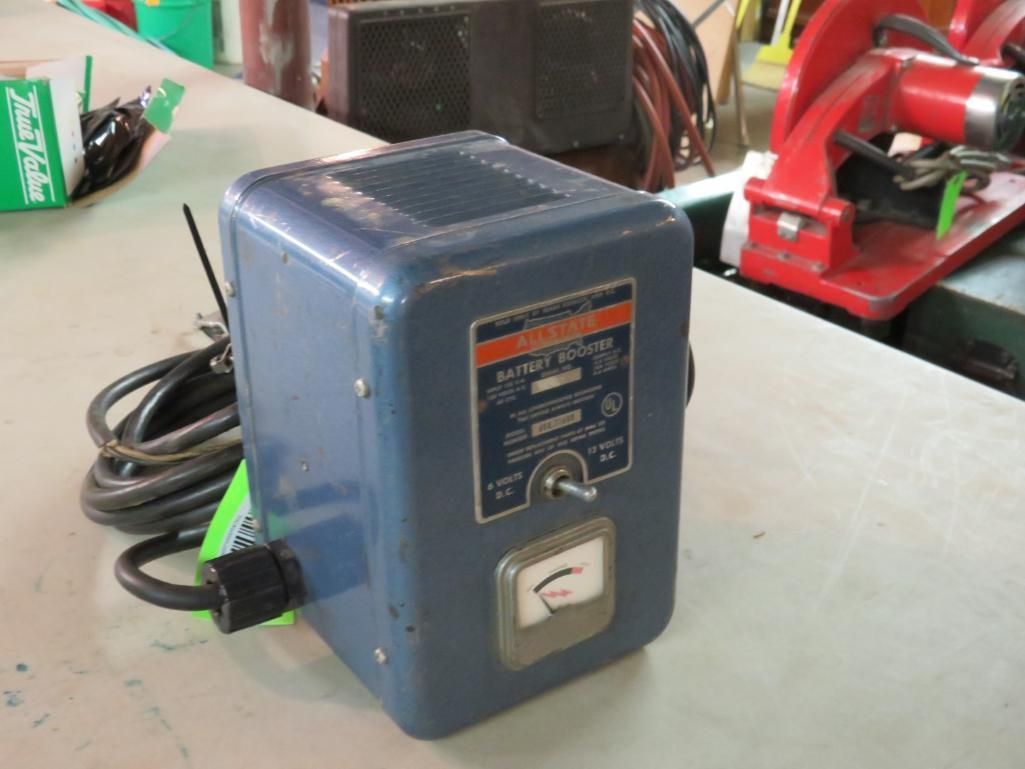 Blue vintage electrical transformer with attached cord and dial, on a white surface.