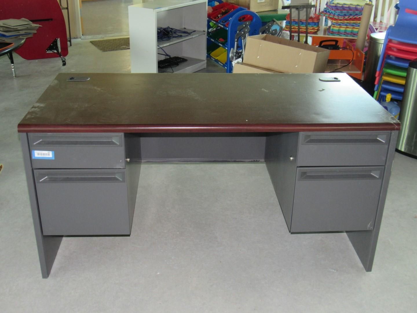 Gray metal desk with drawers and a dark brown desktop.