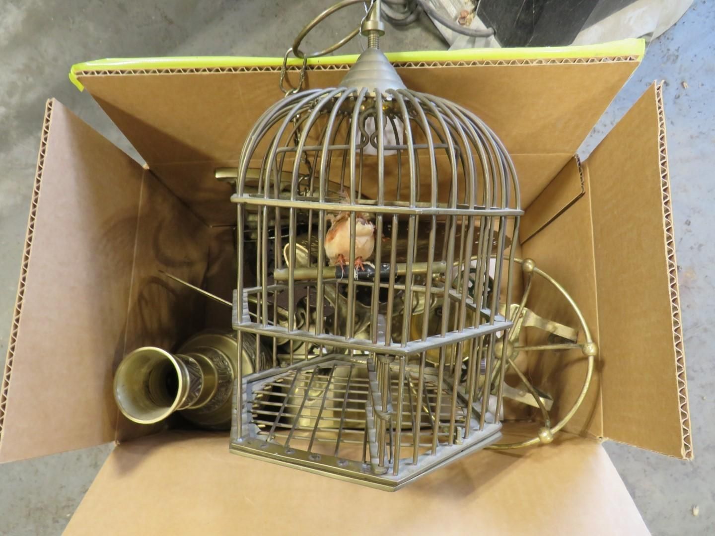 Birdcage, vase, and metal fan parts inside a cardboard box.