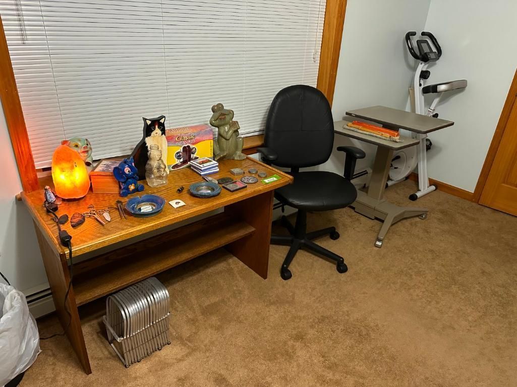 Desk with items, a cat statue, and an office chair.
