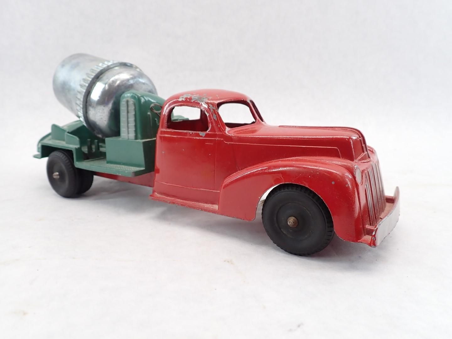 Red and green vintage toy cement truck, side view.