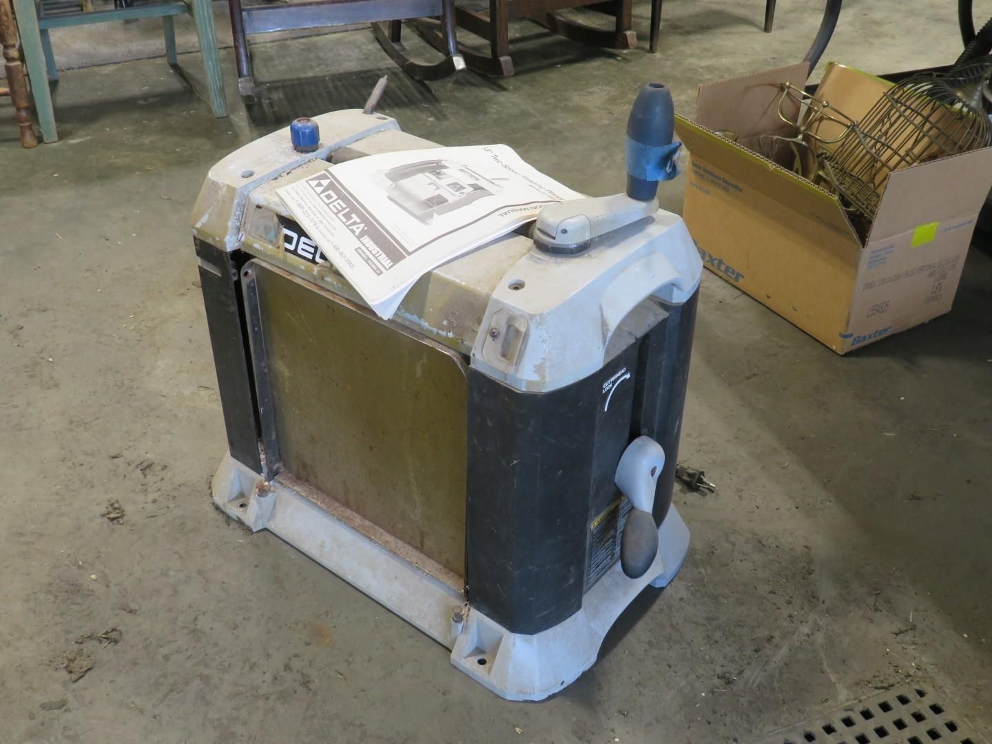 A Delta planer machine on a concrete floor.