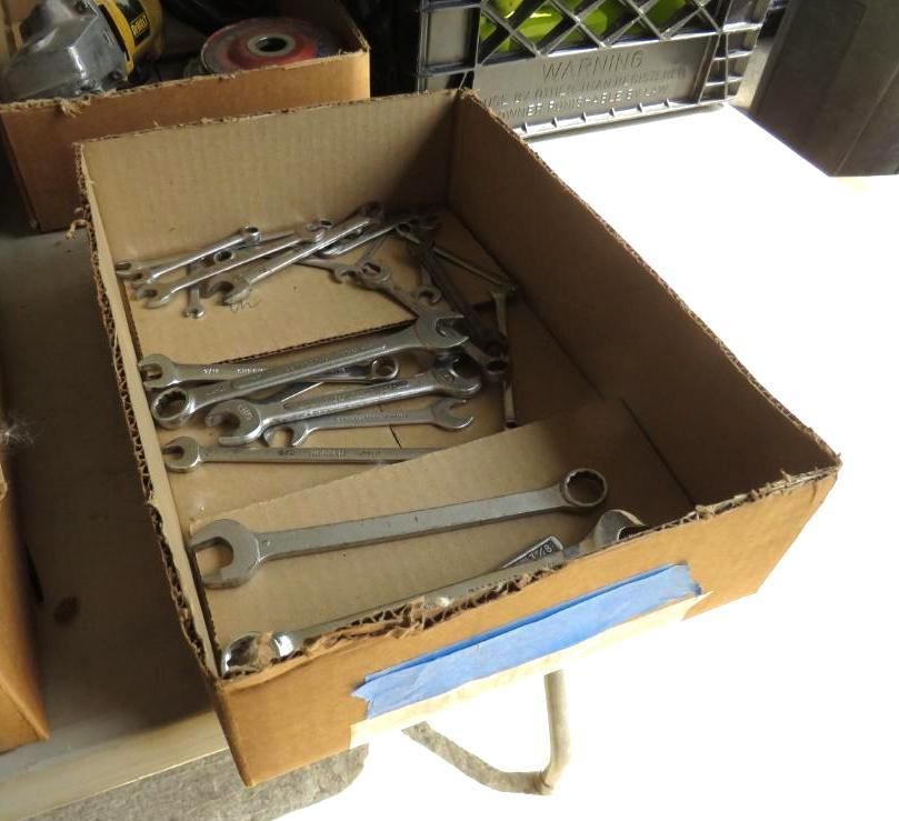 Cardboard box holding several wrenches.