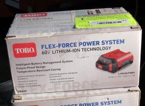Box for a Toro Flex-Force power system 60V lithium-ion battery. Red and black battery graphic, white box, green sticker.