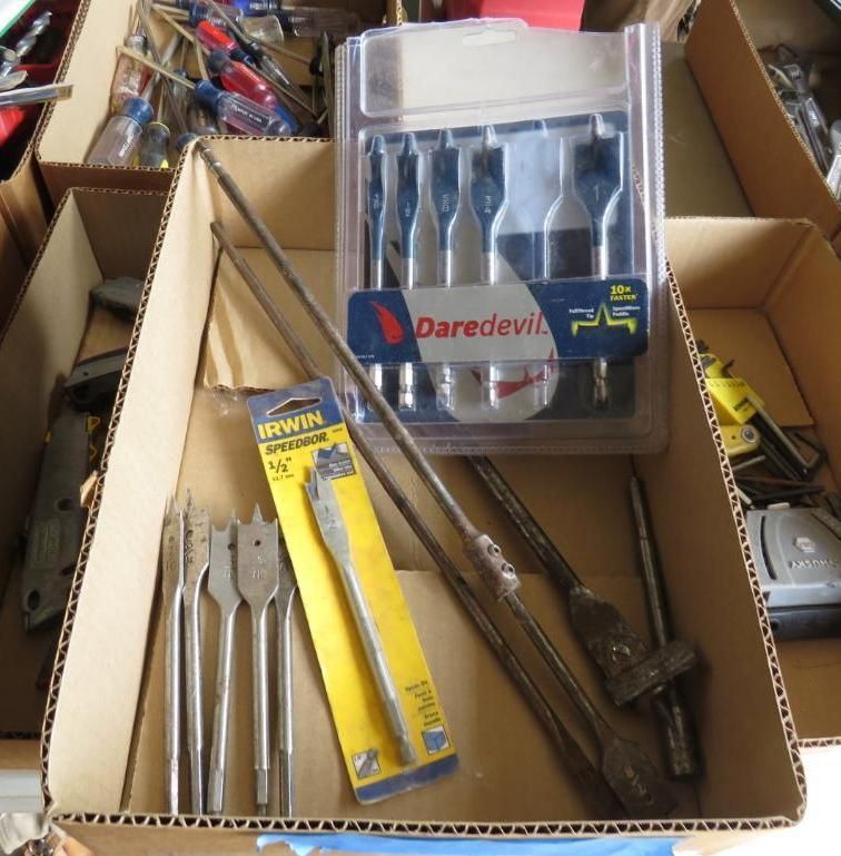 Cardboard box filled with various drill bits and tools.