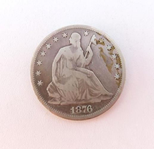 1876 Seated Liberty quarter coin. Silver with seated Liberty on front and stars around the border.