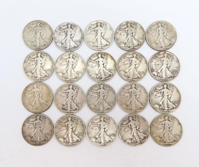 Twenty silver Walking Liberty half dollars arranged on a white surface.