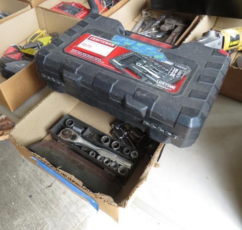 Craftsman tool set in a box; black case atop cardboard box with sockets and wrench.