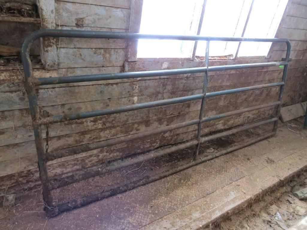 Metal gate, inside a wooden structure.