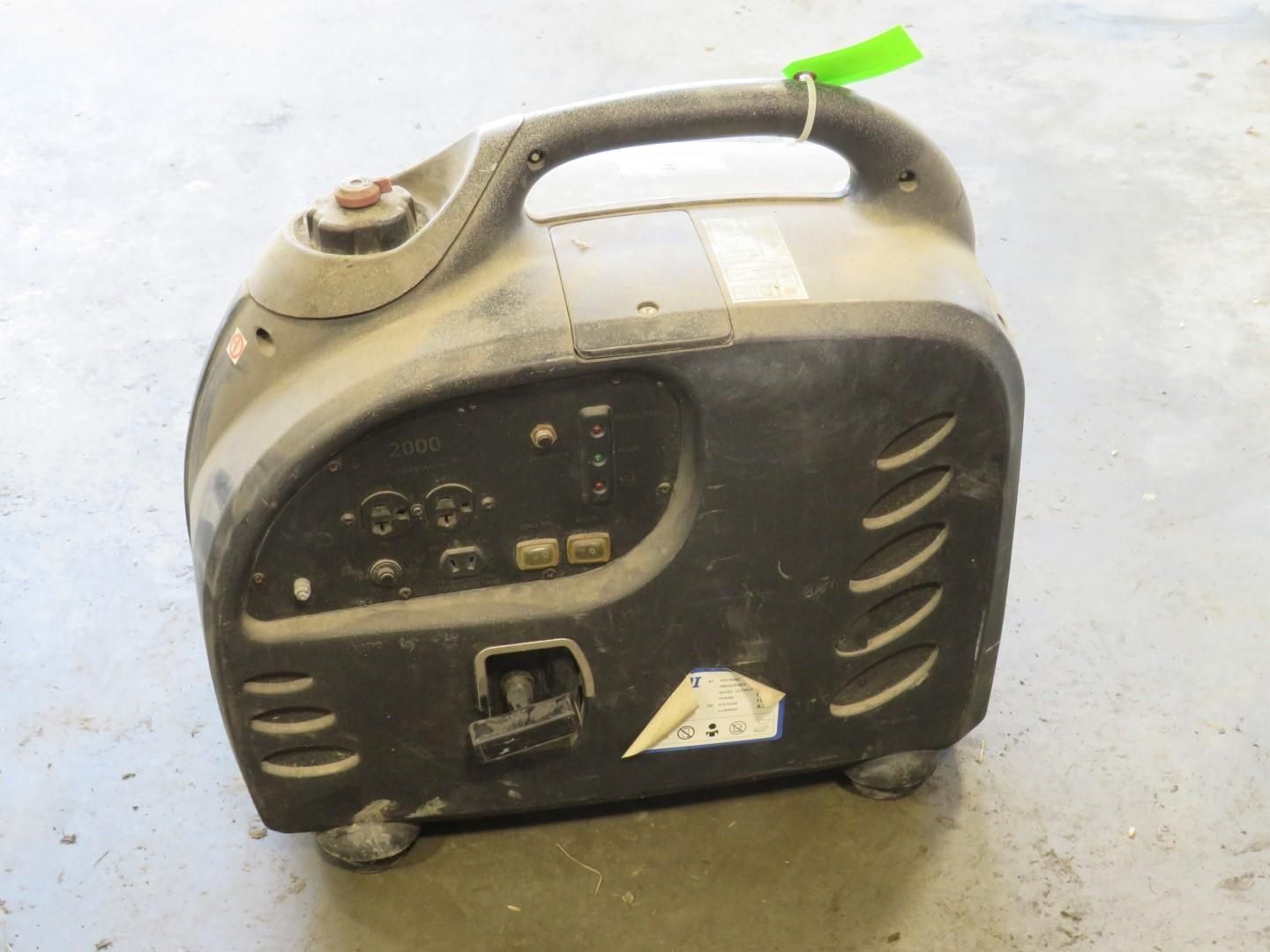 A portable black and gray generator with a handle and control panel.