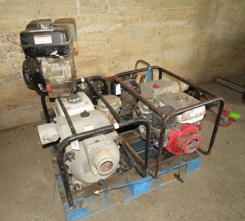 Two water pumps with engines on a blue wooden pallet.