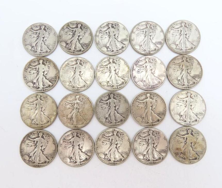Twenty silver Walking Liberty half dollars arranged in a rectangular grid on a white surface.