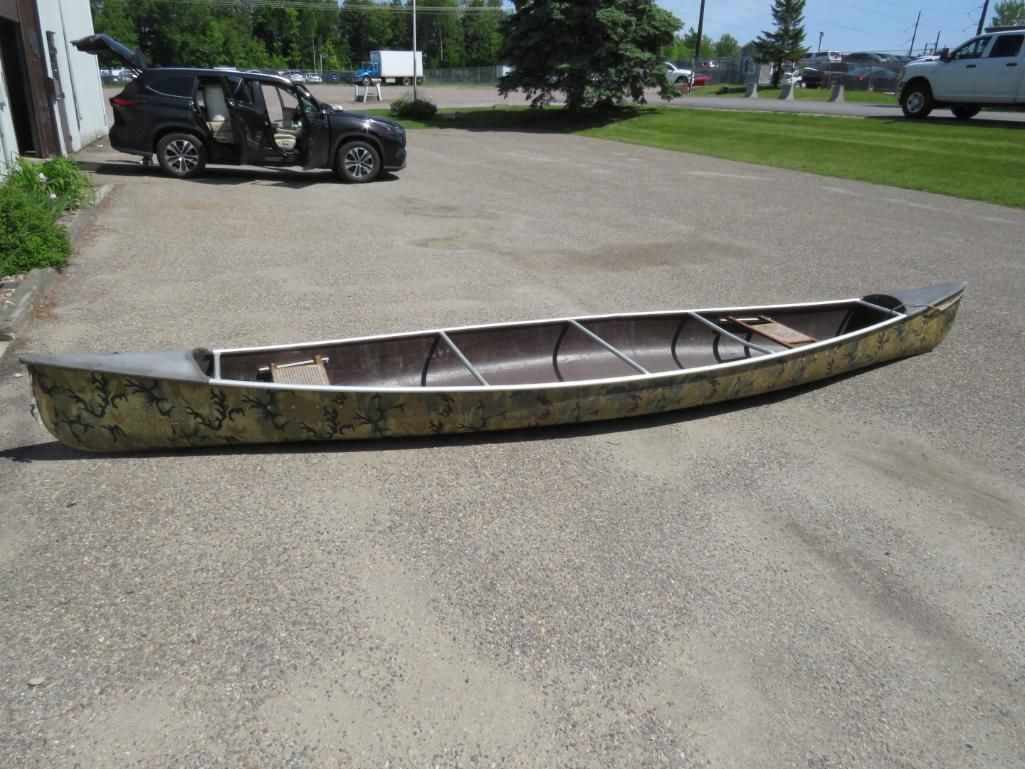 Canoe on asphalt parking lot.