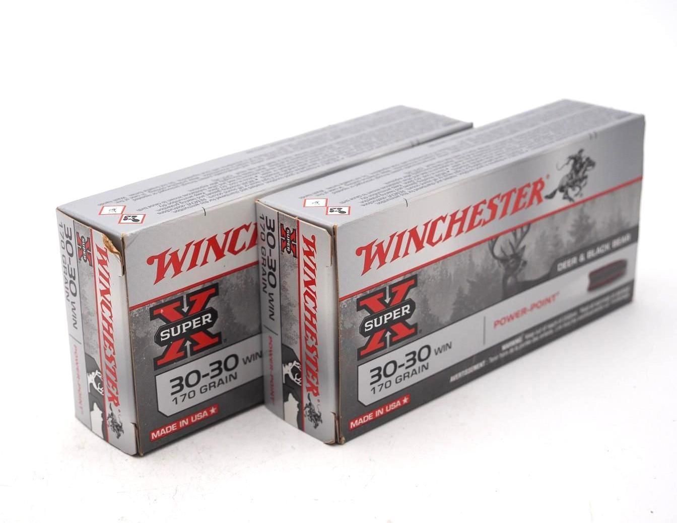 Two Winchester Super-X 30-30 rifle cartridge boxes, red, silver, and black, on a white background