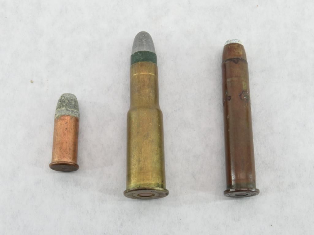 Three different sized bullets on a light background; copper, brass, and dark brown.