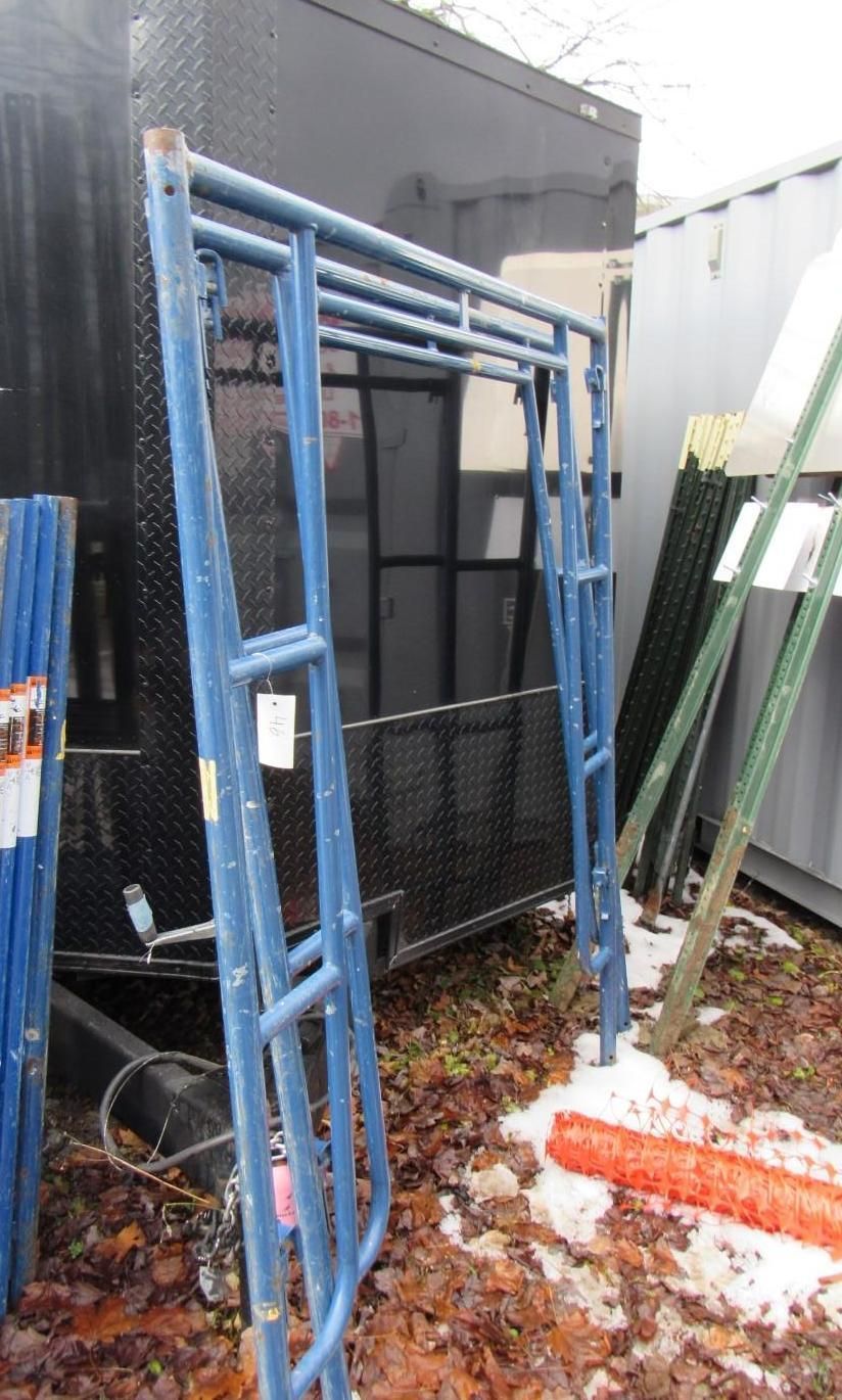 Blue metal scaffolding frame outdoors.