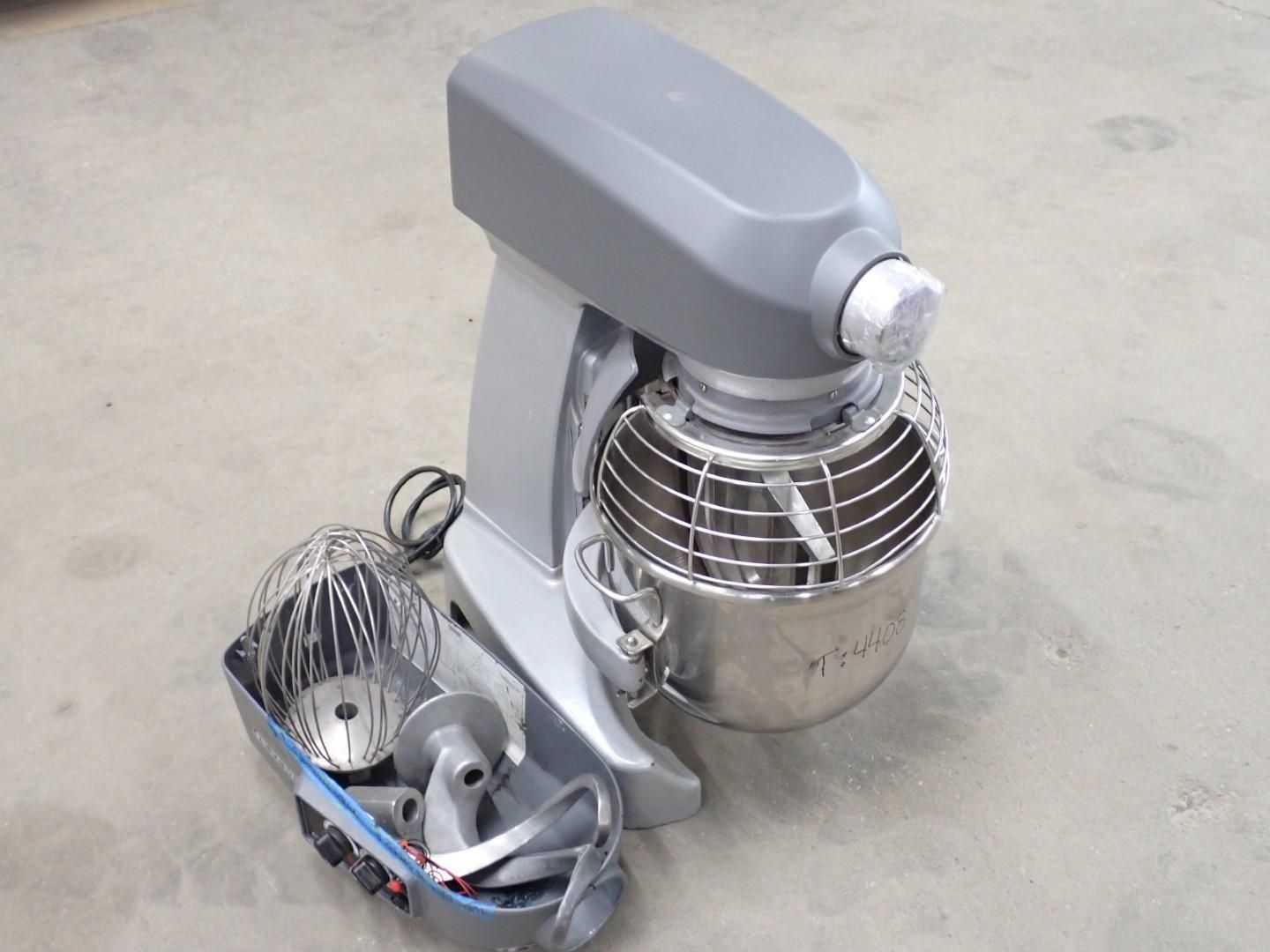 Gray stand mixer with stainless steel bowl and attachments.