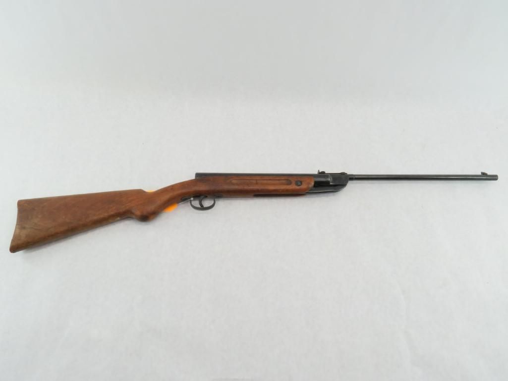 A brown air rifle on a white background.