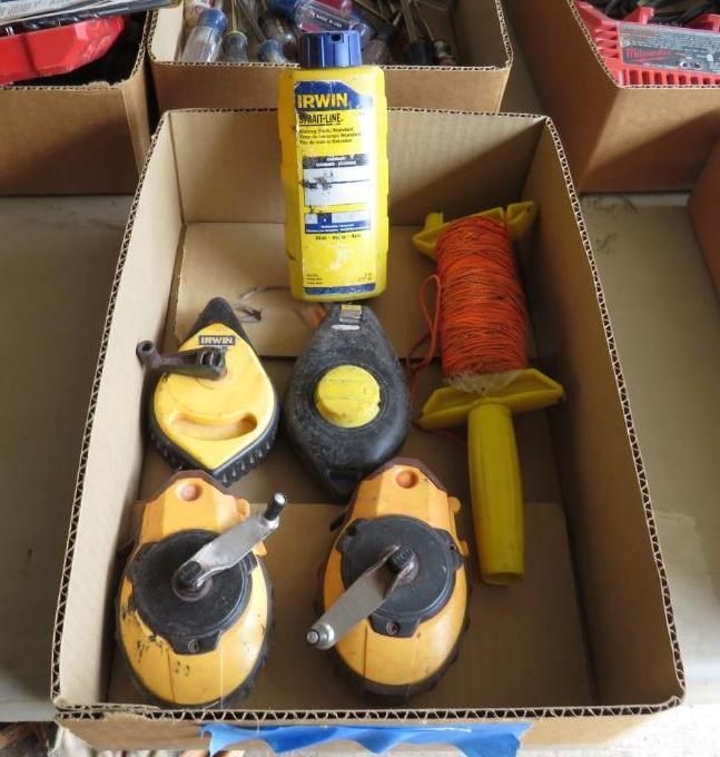 Cardboard box with yellow and black chalk line reels, string reel.