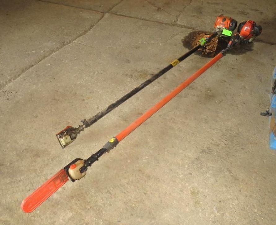 Two gas-powered pole saws on a concrete surface, one black, one orange, engines at top.