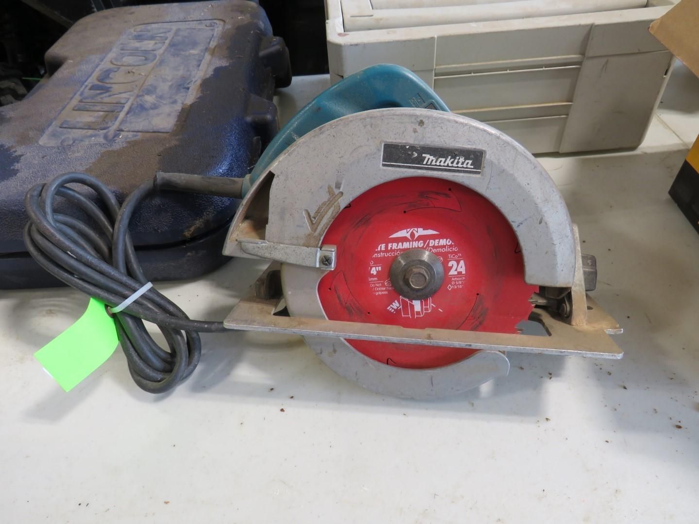 Makita circular saw with a red blade, cord, and green tag.