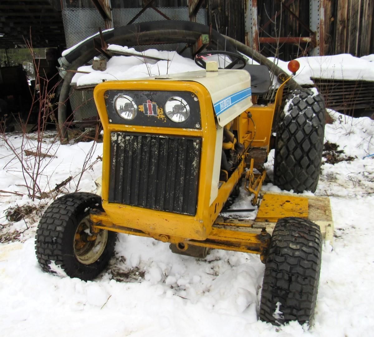 Yellow Cub Cadet tractor in snow.